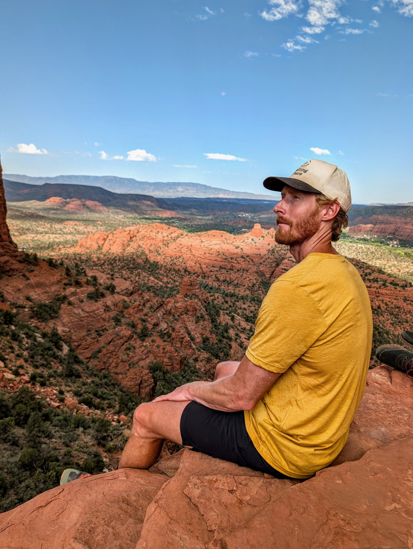 Nate Langley standing on red rock overlooking the Sedona valley