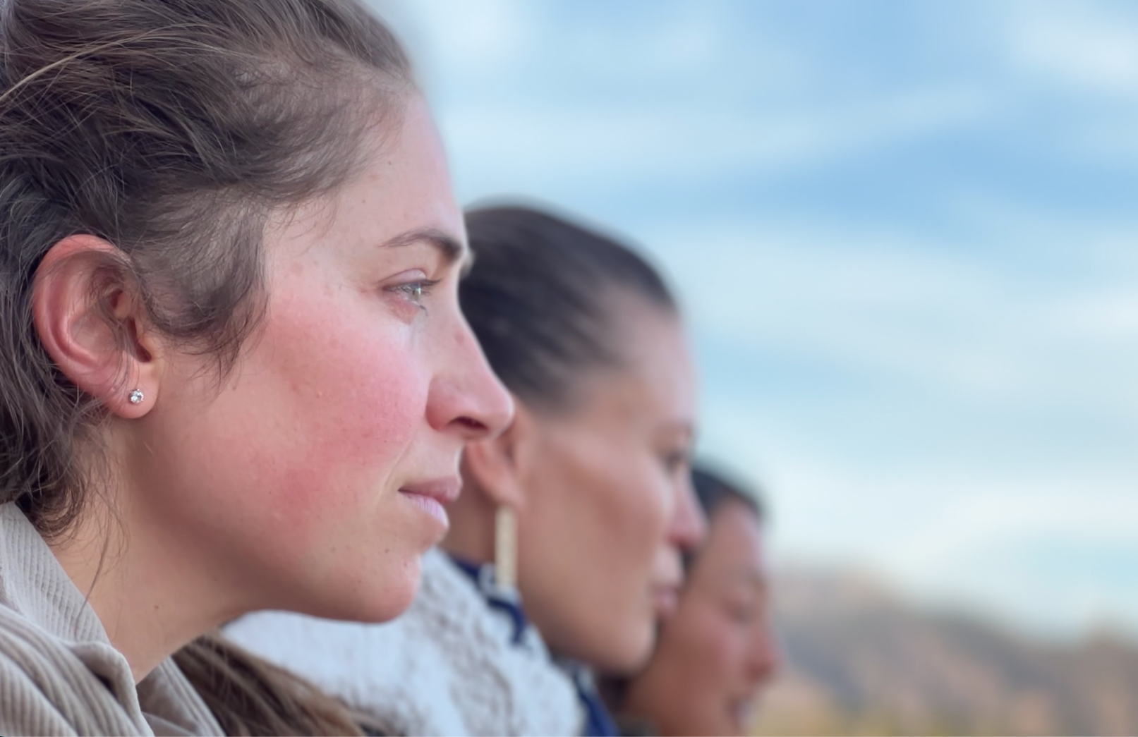 Three participants looking out toward the horizon