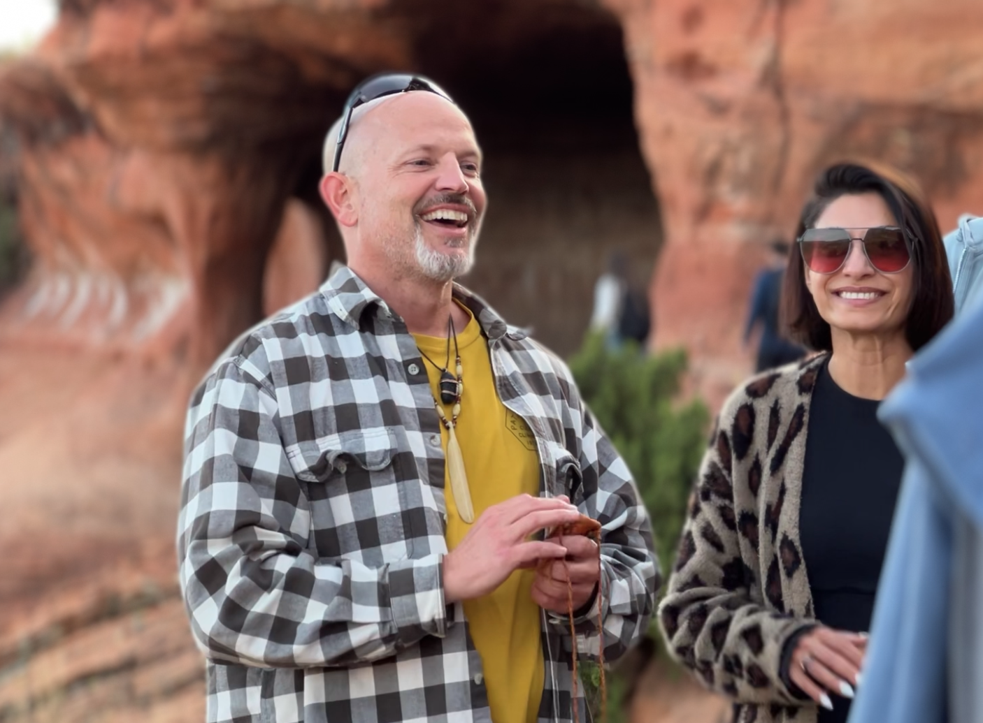 A man laughing with the group in front of Sedona red rock