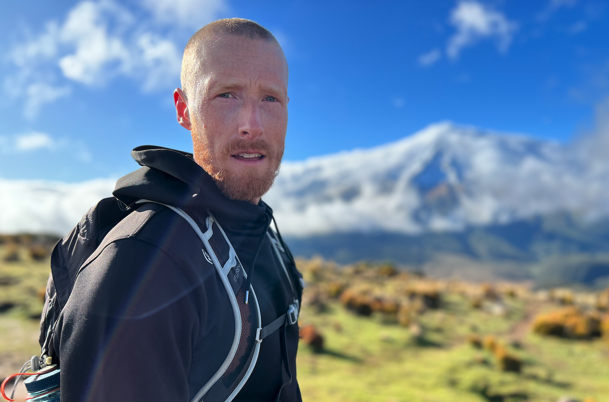 Nate Langley outdoors with a mountain backdrop